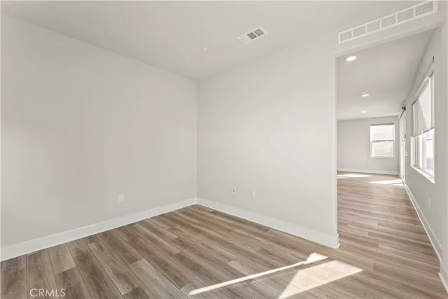 a view of a room with wooden floor and a window
