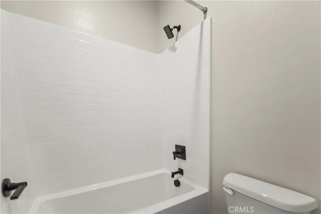 a white bath tub sitting next to a toilet