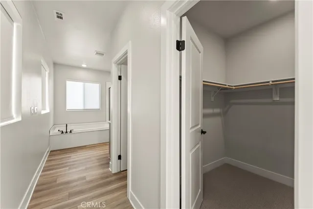 a white toilet sitting next to a white wall