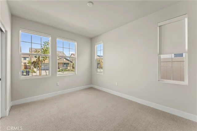 an empty room with windows and closet