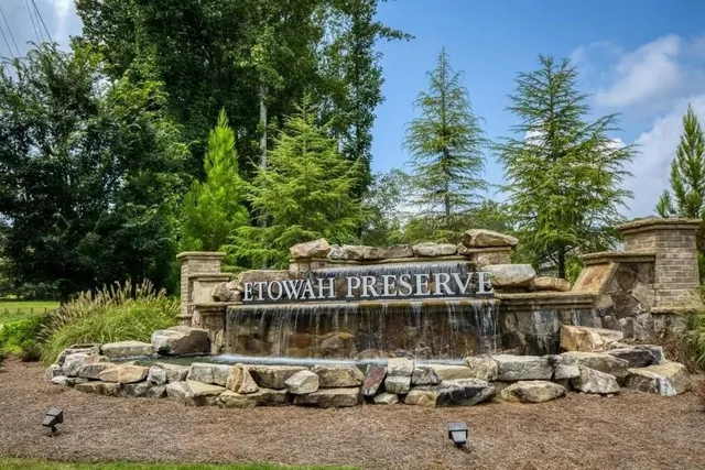 a front view of a building with trees