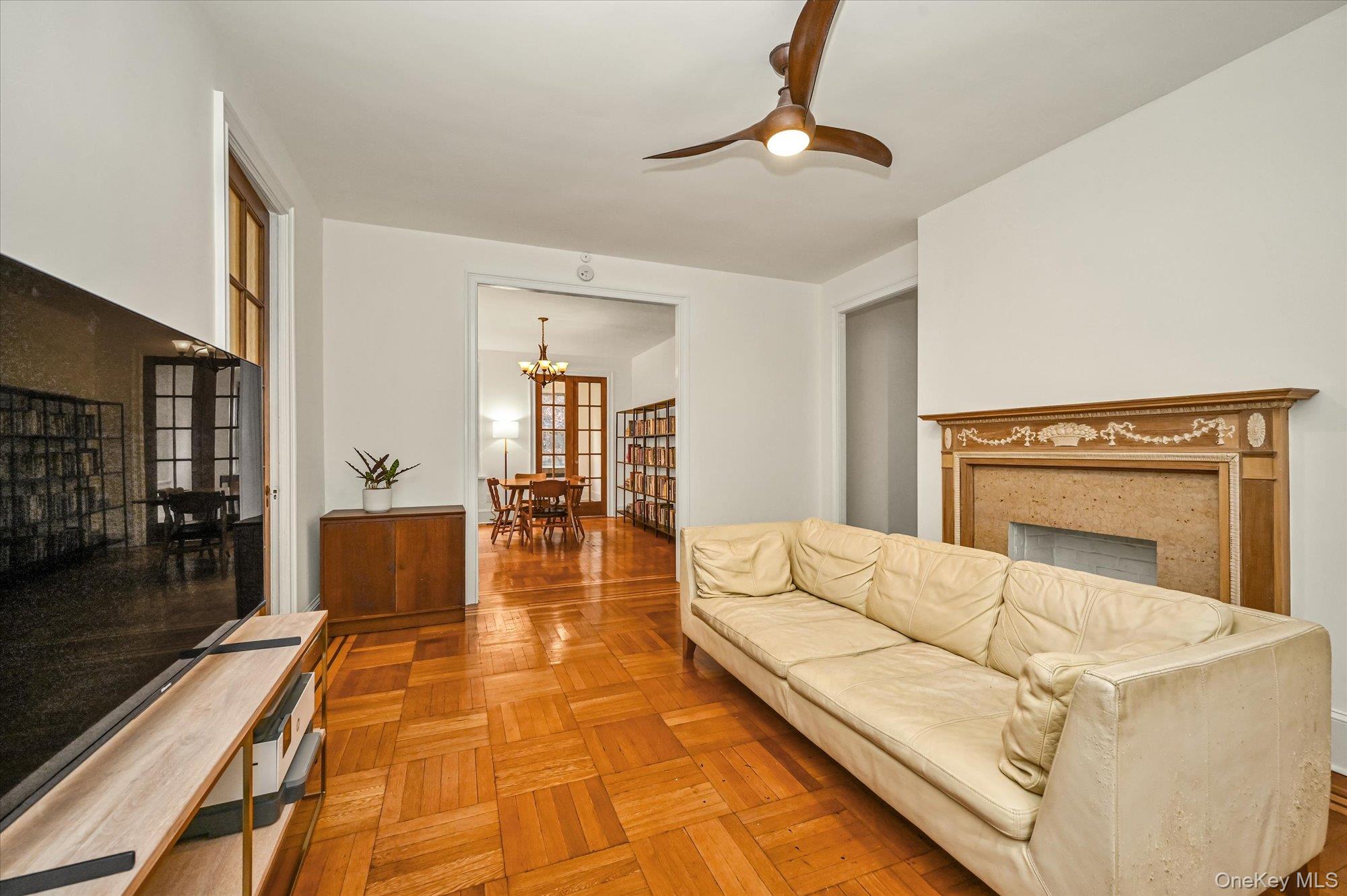 37-16 80th Street, Unit 2 Queens, NY 11372 - Photo 3 of 18 a living room with furniture and a fireplace