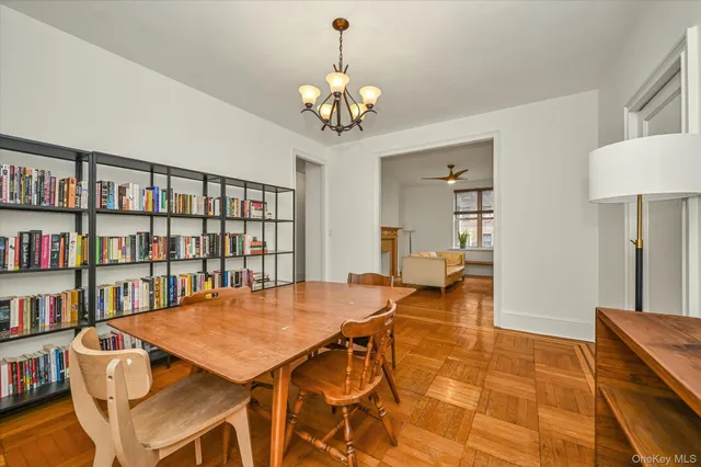 a view of a dining room with furniture and a chandelier