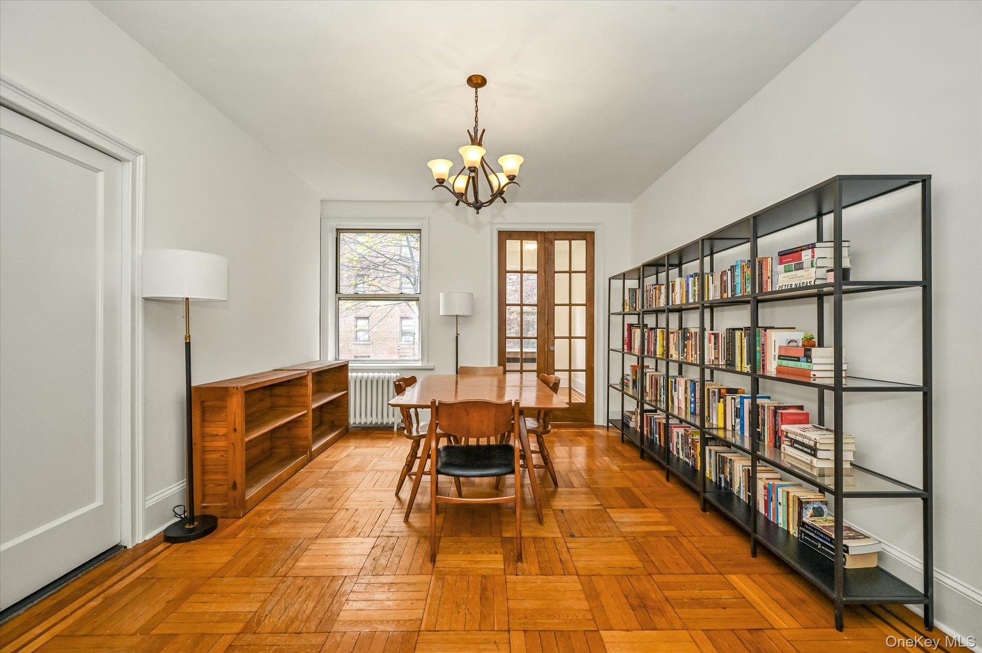 37-16 80th Street, Unit 2 Queens, NY 11372 - Photo 5 of 18 a living room with furniture a chandelier and a rug