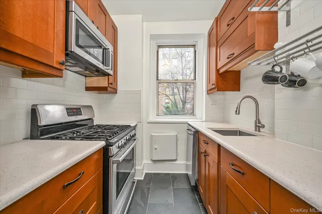 a kitchen with stainless steel appliances granite countertop a stove and a sink