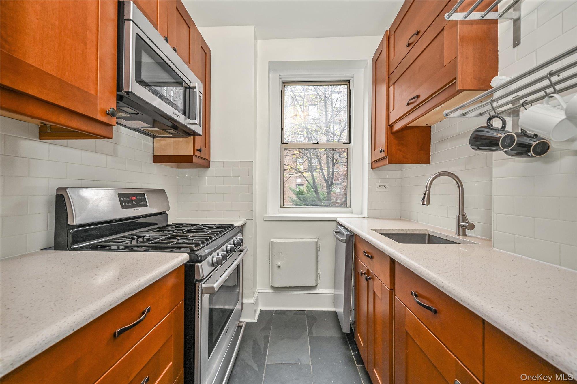 37-16 80th Street, Unit 2 Queens, NY 11372 - Photo 7 of 18 a kitchen with stainless steel appliances granite countertop a sink stove and cabinets