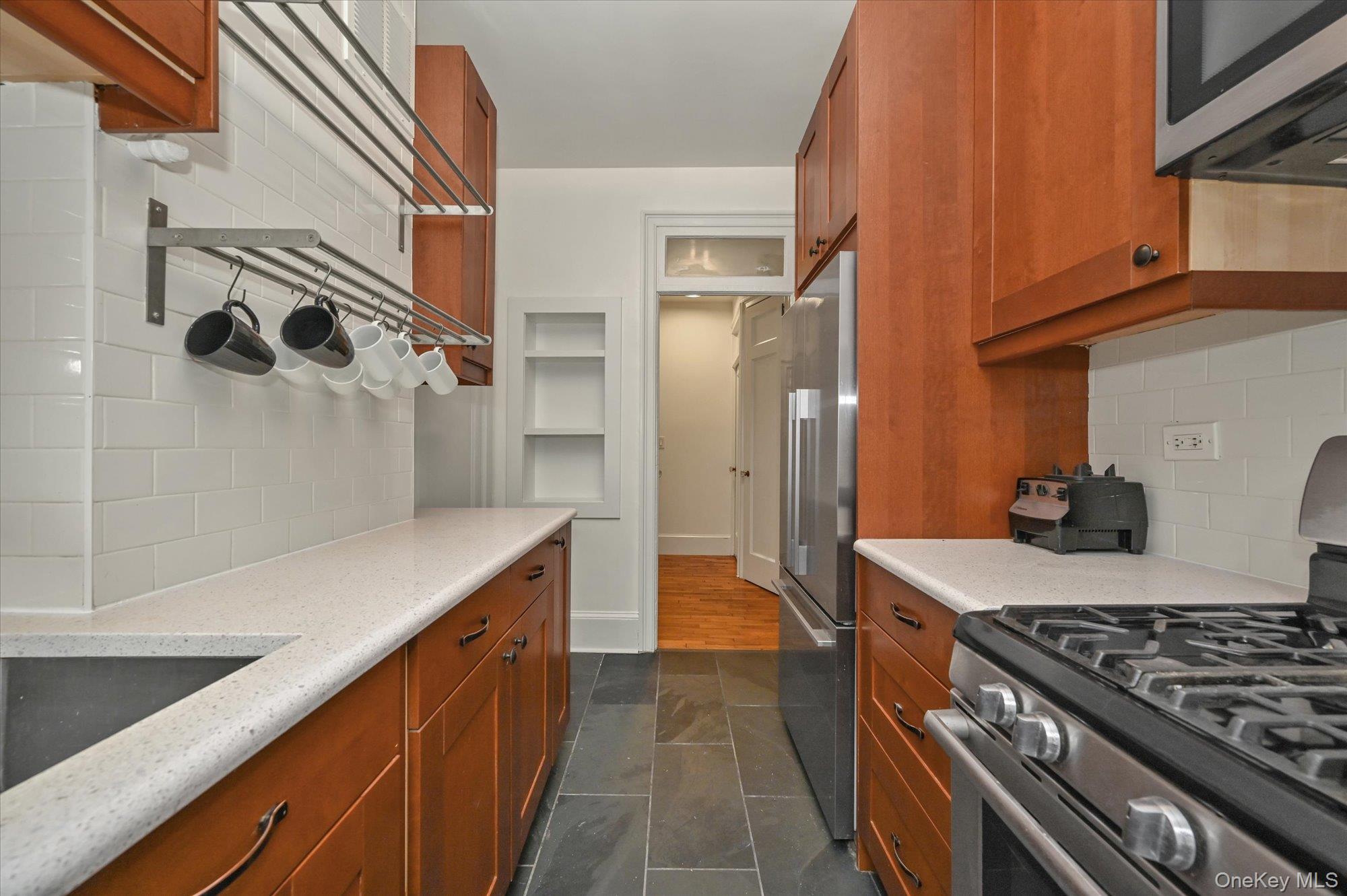 37-16 80th Street, Unit 2 Queens, NY 11372 - Photo 8 of 18 a kitchen with stainless steel appliances granite countertop a stove and a sink