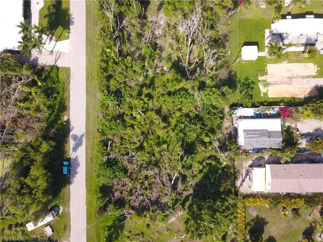 a bird view of residential house with swimming pool and lawn chairs