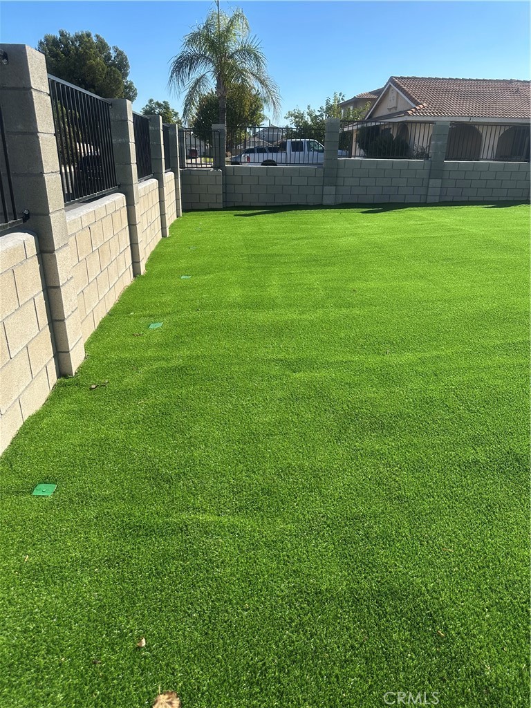 1029-1029 West Madrona Street Rialto, CA 92376 - Photo 16 of 19 a view of yard with grass and a trees