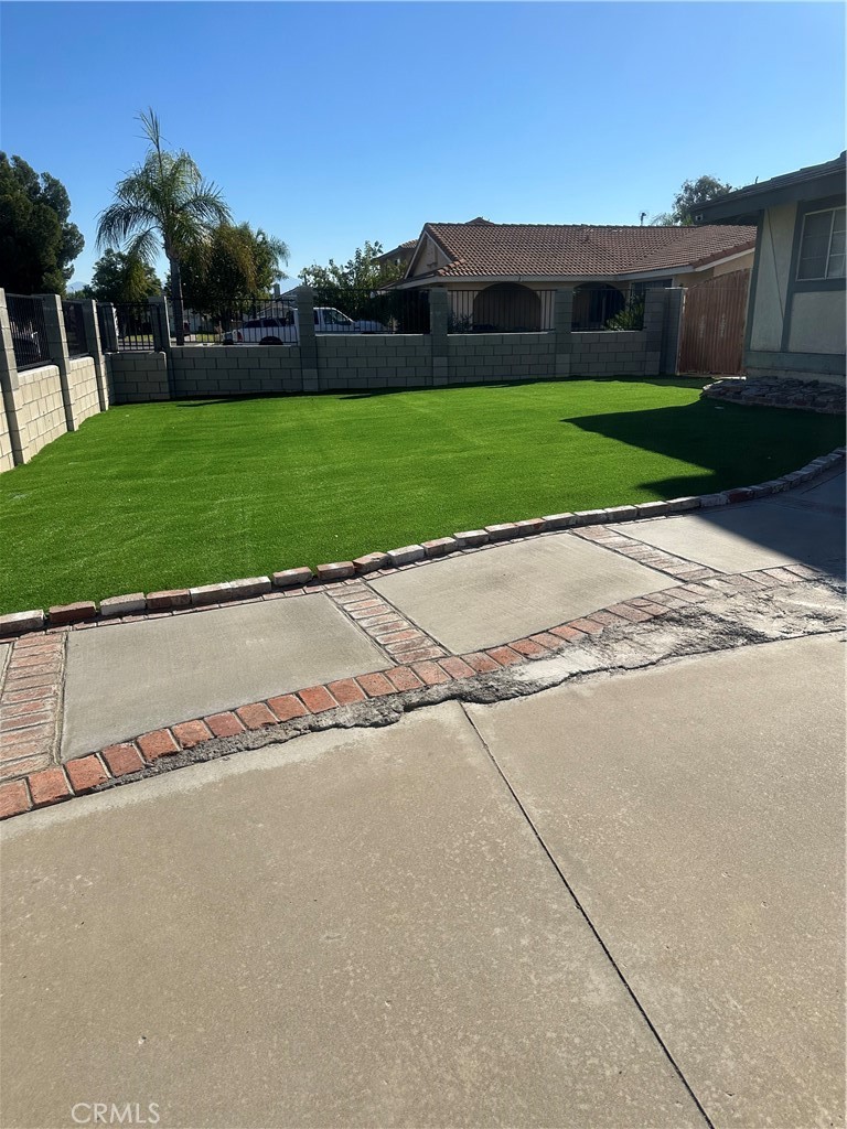 1029-1029 West Madrona Street Rialto, CA 92376 - Photo 18 of 19 a view of a street with a garden and large trees