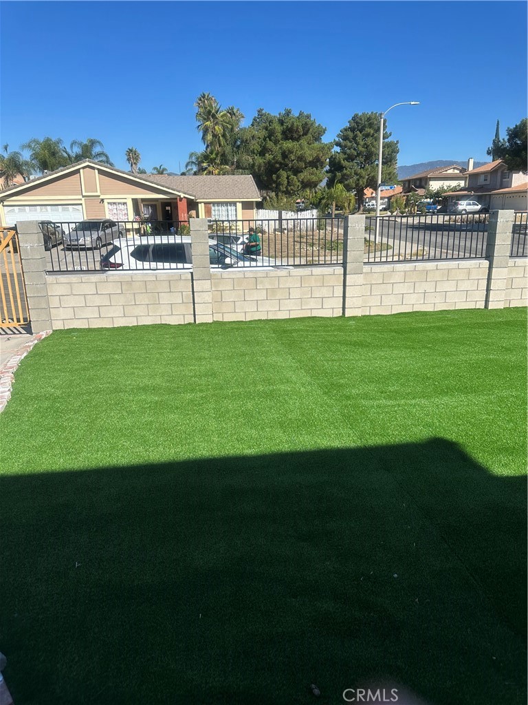 1029-1029 West Madrona Street Rialto, CA 92376 - Photo 3 of 19 a view of a house with a garden