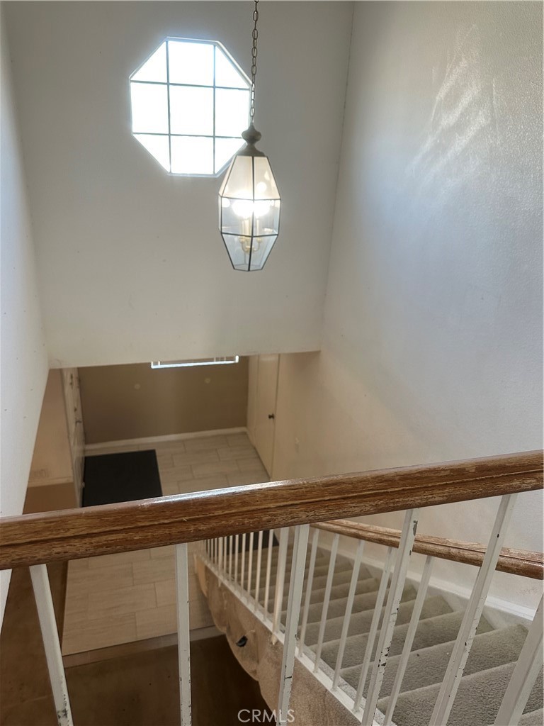 1029-1029 West Madrona Street Rialto, CA 92376 - Photo 5 of 19 a view of staircase with railing and a window
