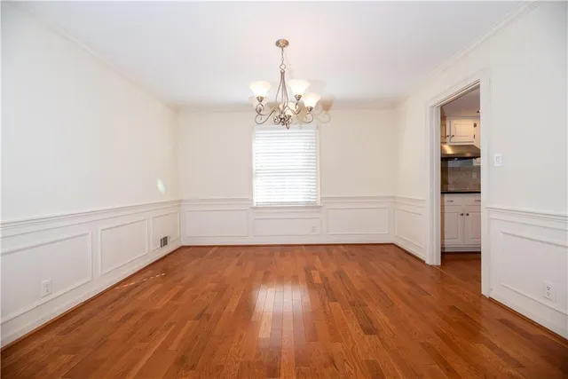 a living room with furniture a flat screen tv and a large window