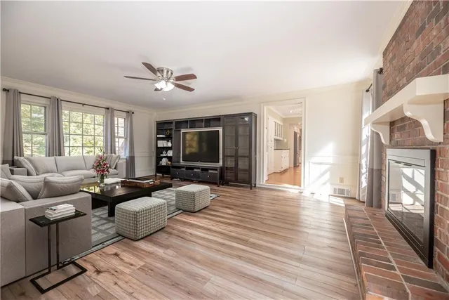 a view of a room with a ceiling fan and a window