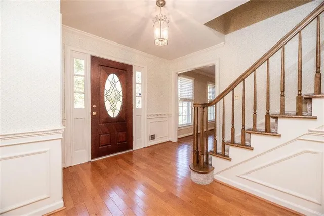a view of an entryway with wooden floor