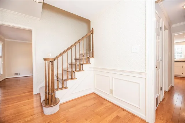 a view of entryway and hall with wooden floor