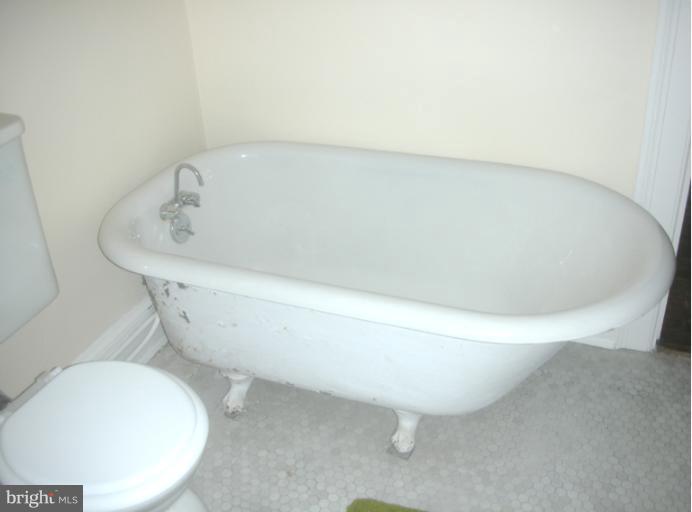 3903 Canterbury Road Baltimore, MD 21218 - Photo 24 of 27 a white bath tub sitting in a bathroom