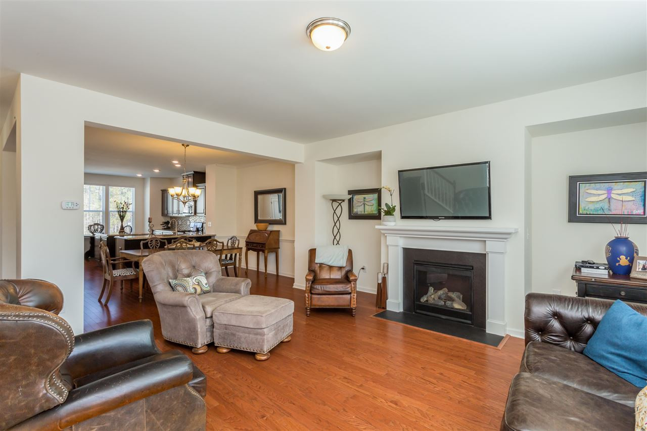 605 Edgewater Ridge Court Apex, NC 27523 - Photo 9 of 25 Family room features a gas-log fireplace with TV connection above.