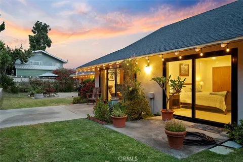 a view of a porch with furniture and a yard