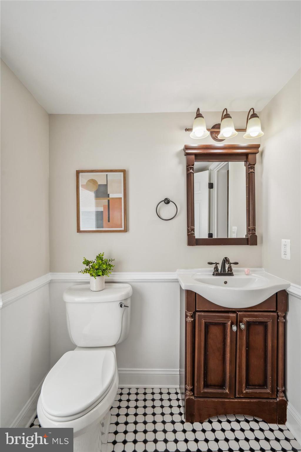 10117 High Ridge Road Laurel, MD 20723 - Photo 34 of 70 a bathroom with a toilet a sink and mirror