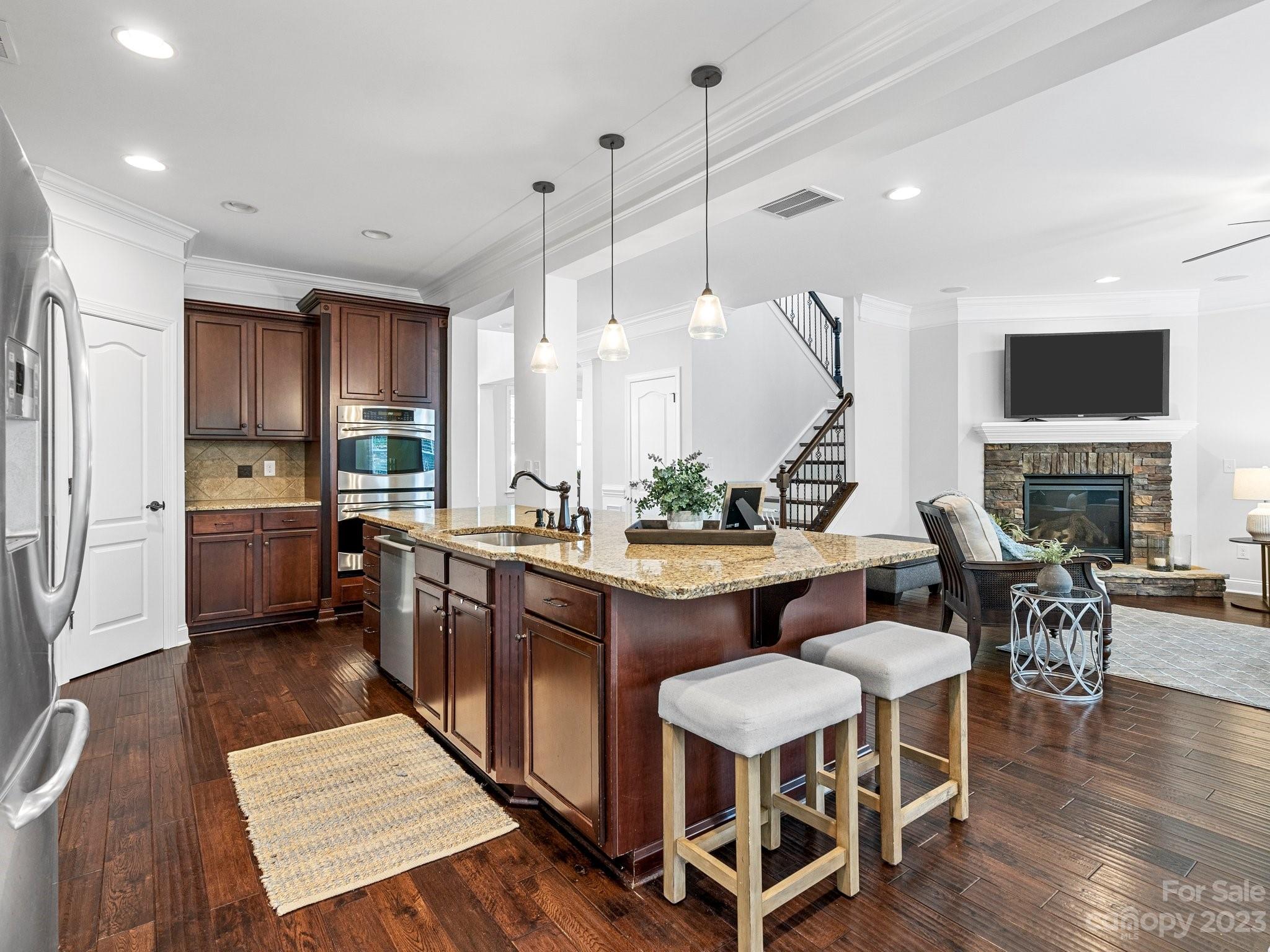 1021 Ridgehaven Road Waxhaw, NC 28173 - Photo 11 of 36 a kitchen with a table chairs sink and cabinets