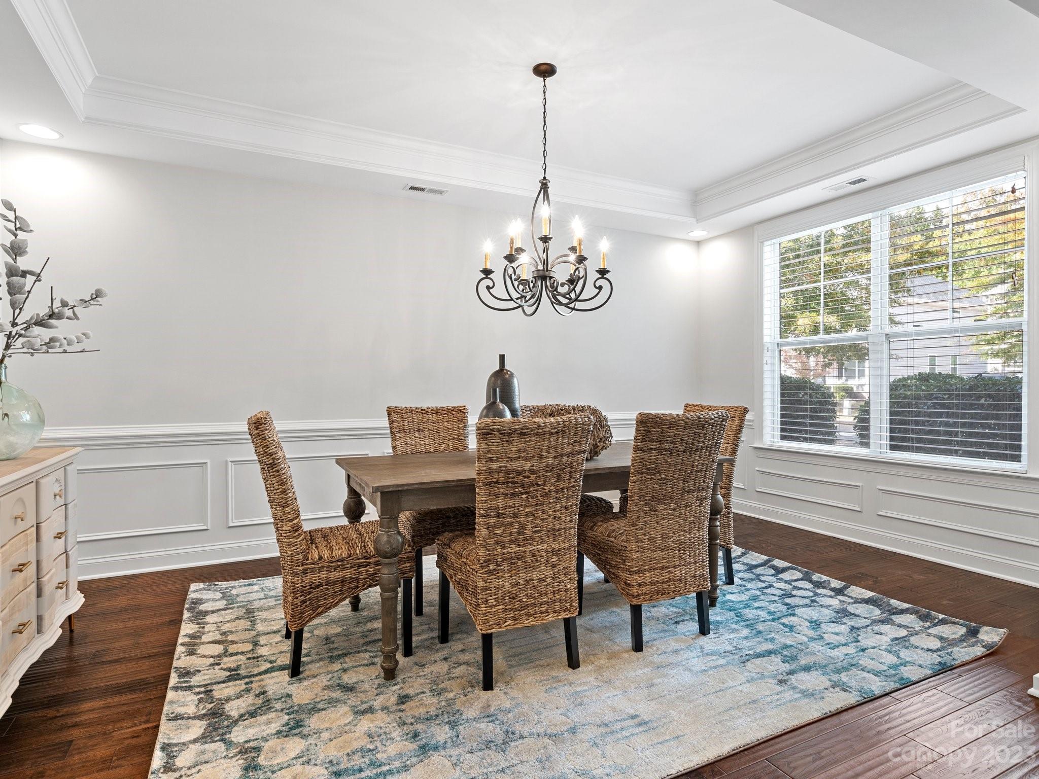 1021 Ridgehaven Road Waxhaw, NC 28173 - Photo 6 of 36 a dining room with furniture a rug and wooden floor