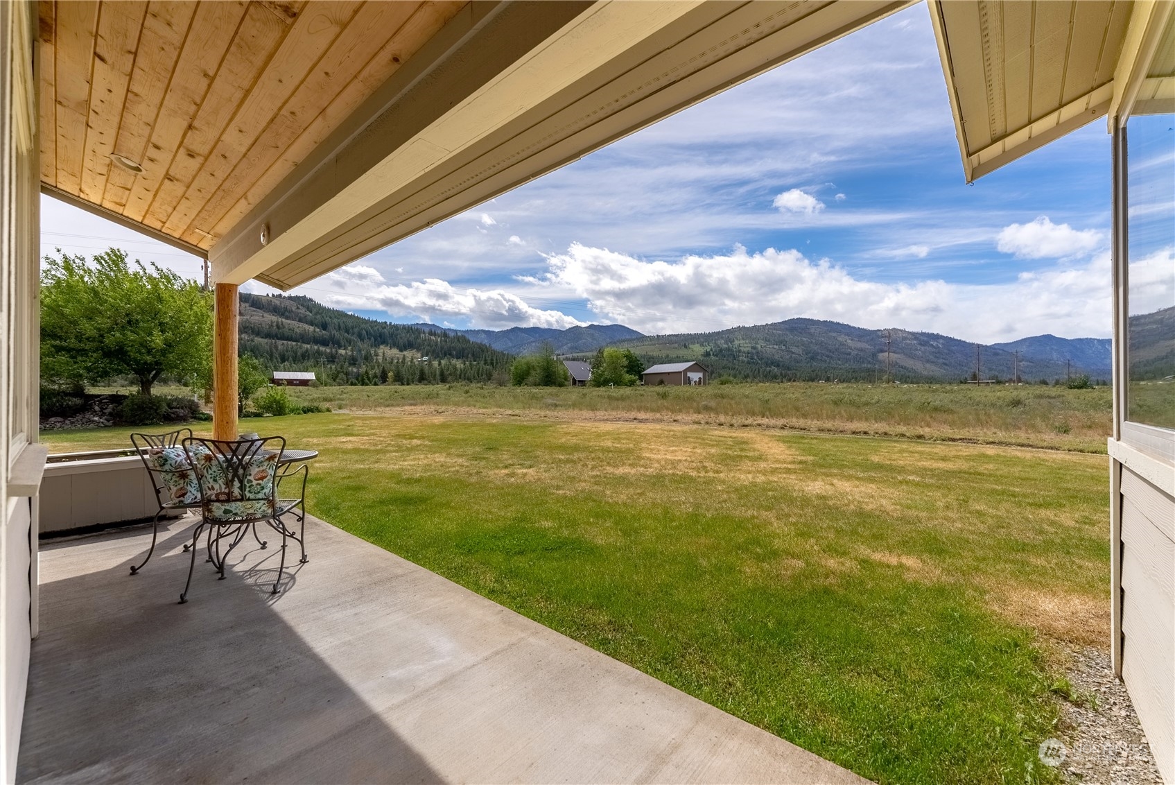 5 Wolfden Road Winthrop, WA 98862 - Photo 11 of 40 a view of a lake with a table and chairs