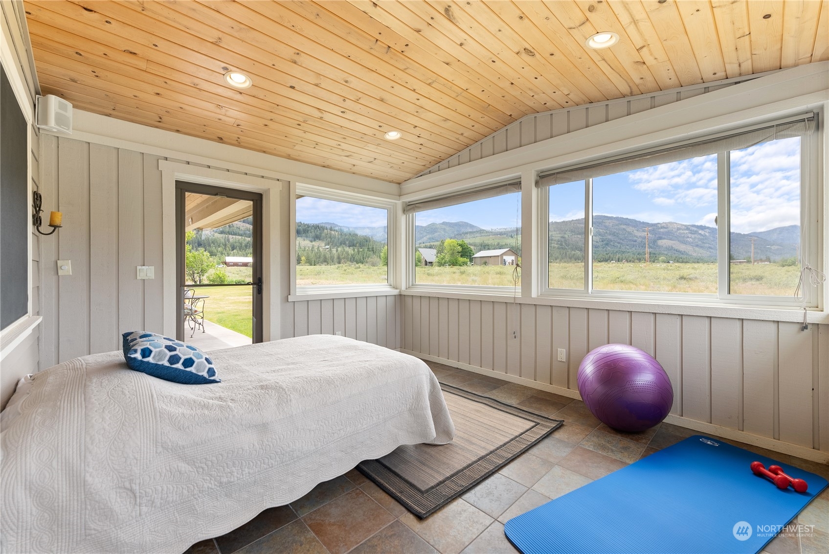 5 Wolfden Road Winthrop, WA 98862 - Photo 22 of 40 a bedroom with a bed and large windows