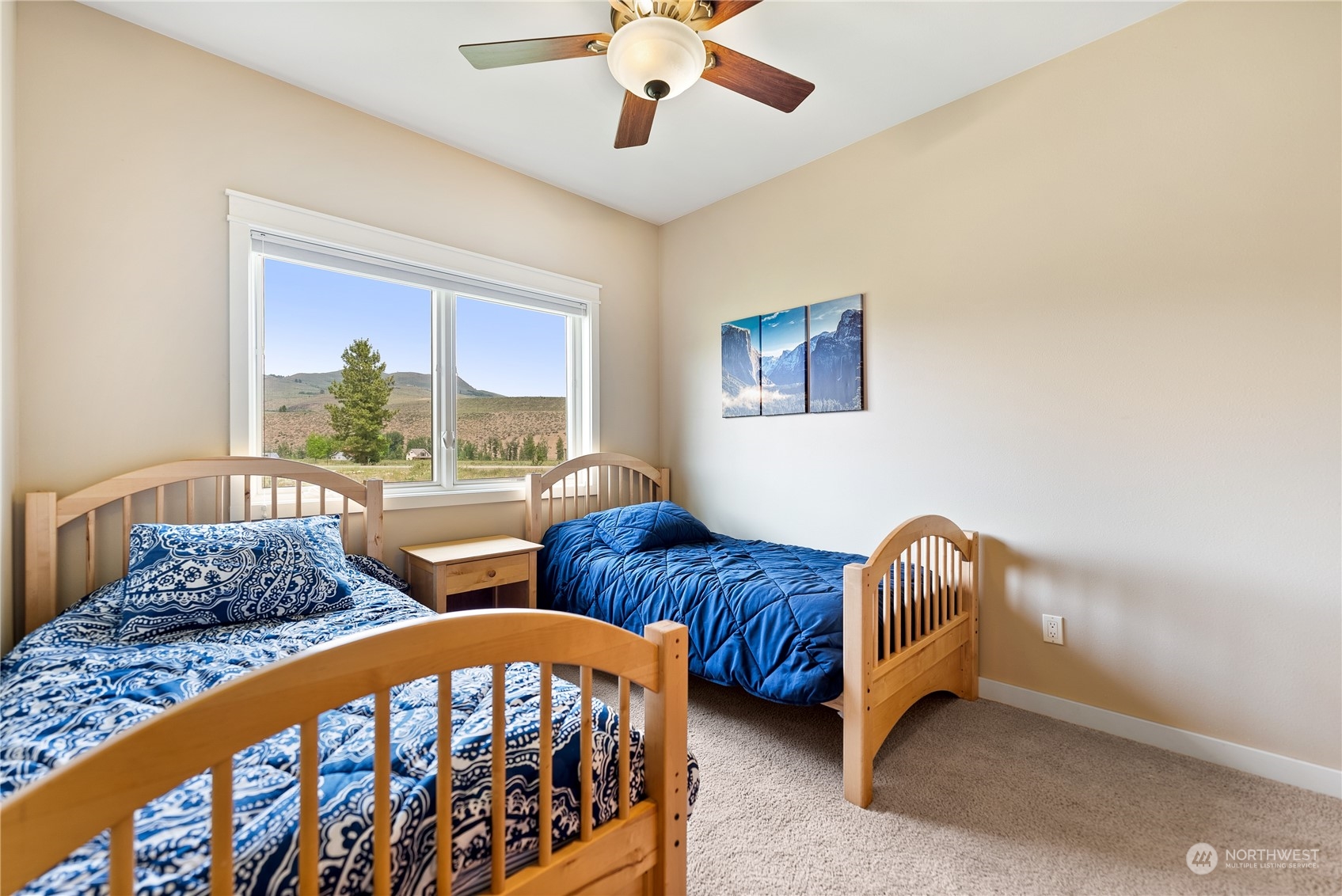 5 Wolfden Road Winthrop, WA 98862 - Photo 30 of 40 a bedroom with two beds and a large window