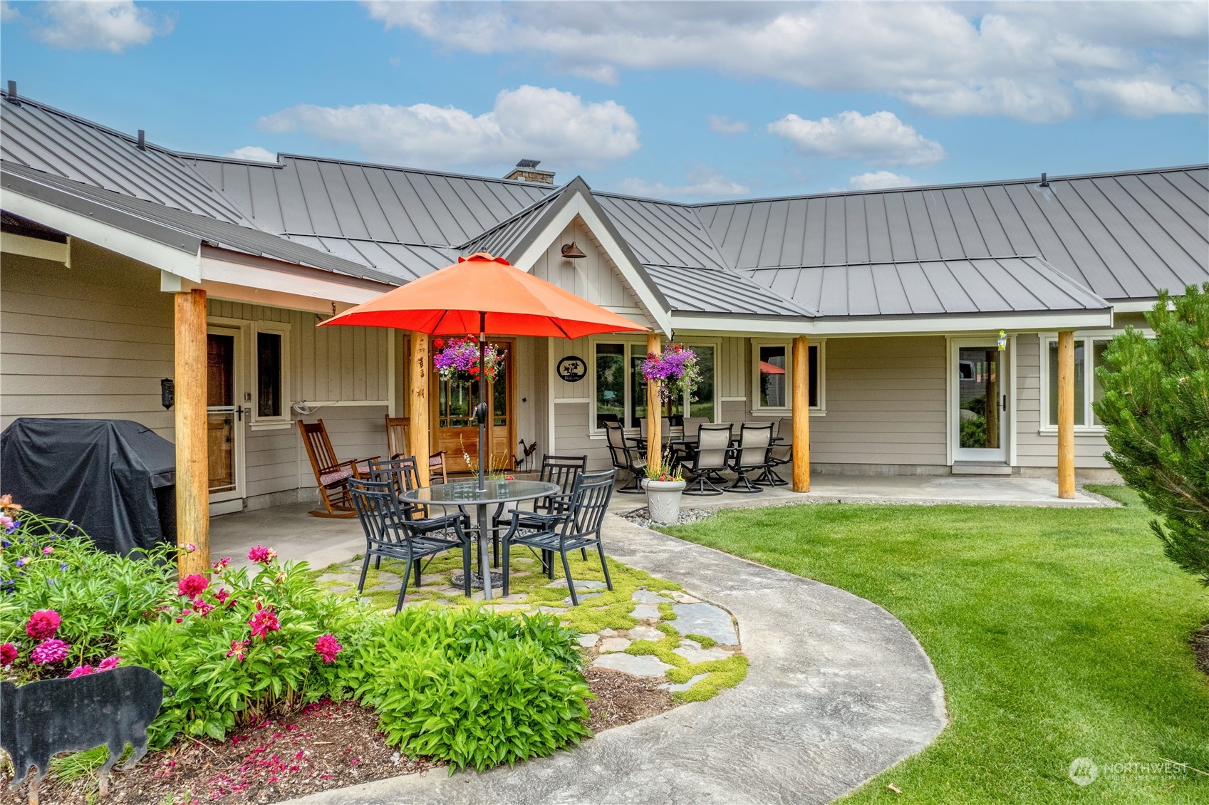 5 Wolfden Road Winthrop, WA 98862 - Photo 5 of 40 a patio with a table and chairs under an umbrella