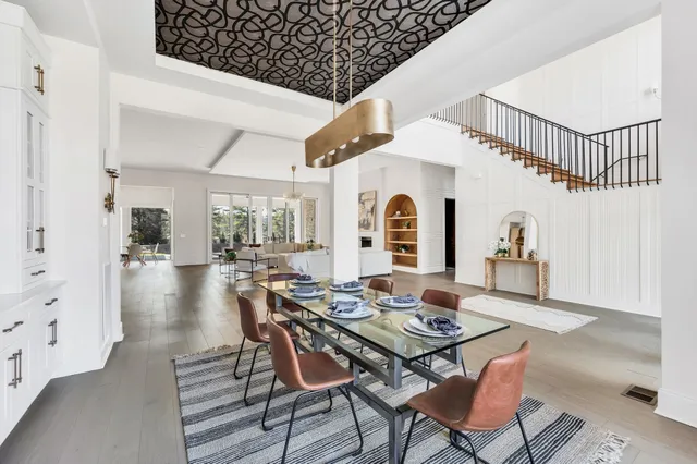 a living room with fireplace furniture and a chandelier