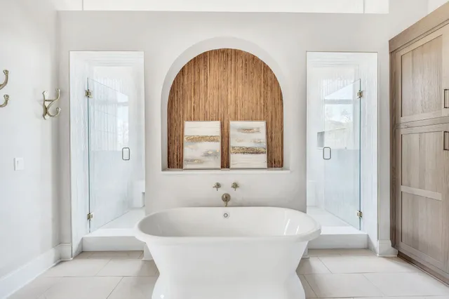 a spacious bedroom with a large bed and a chandelier