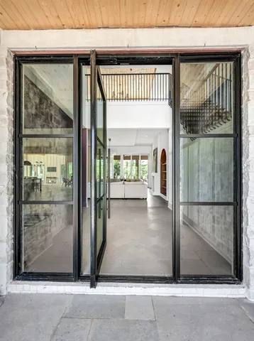 a outdoor dining space with furniture and wooden floor