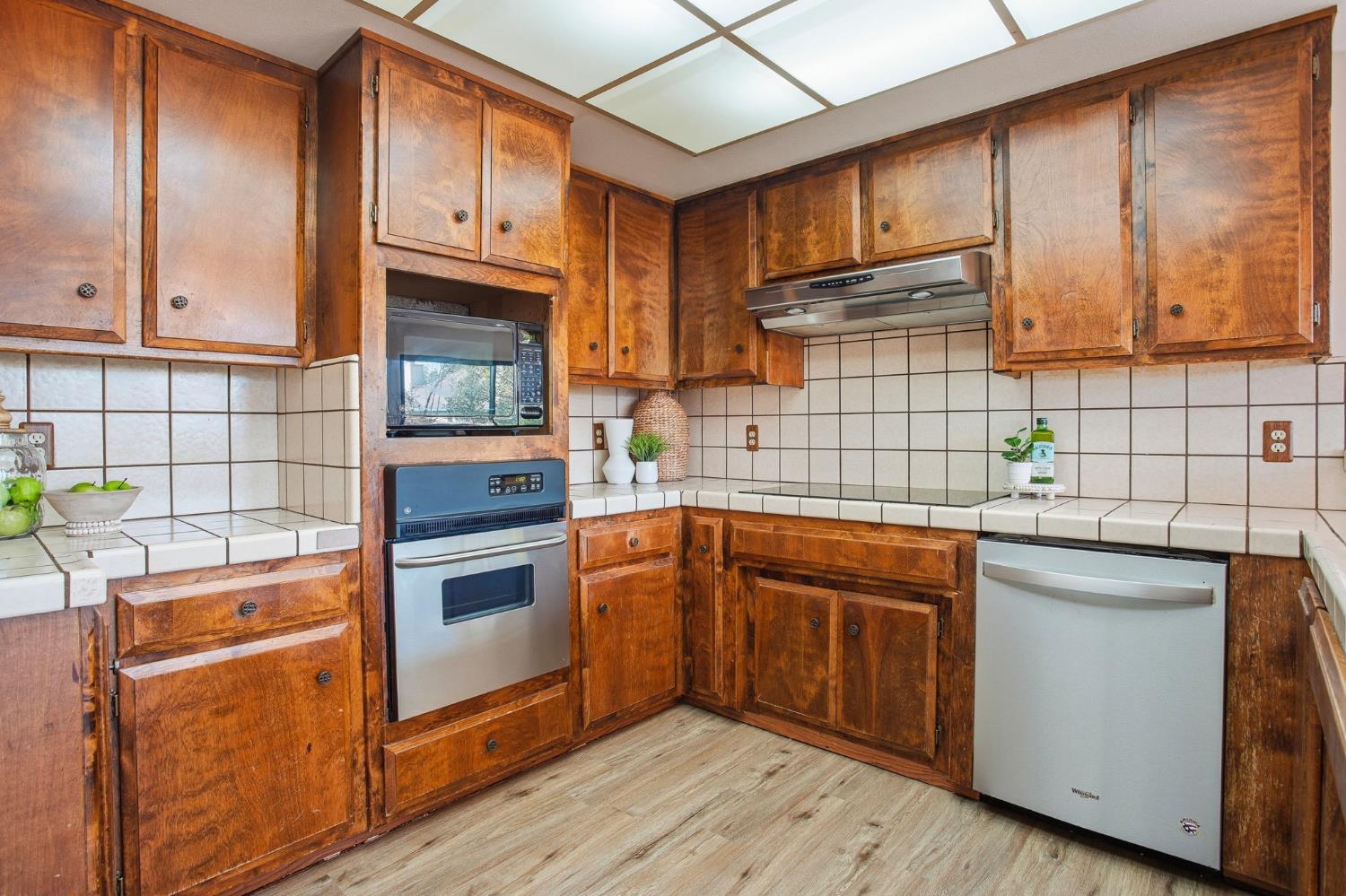 6923 Pera Drive Rancho Murieta, CA 95683 - Photo 12 of 35 a kitchen with stainless steel appliances granite countertop a sink a stove and cabinets
