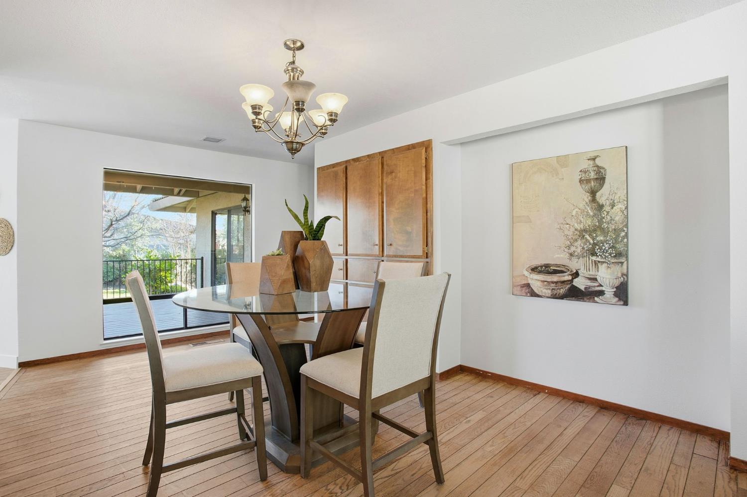 6923 Pera Drive Rancho Murieta, CA 95683 - Photo 17 of 35 a view of a dining room with furniture wooden floor and chandelier