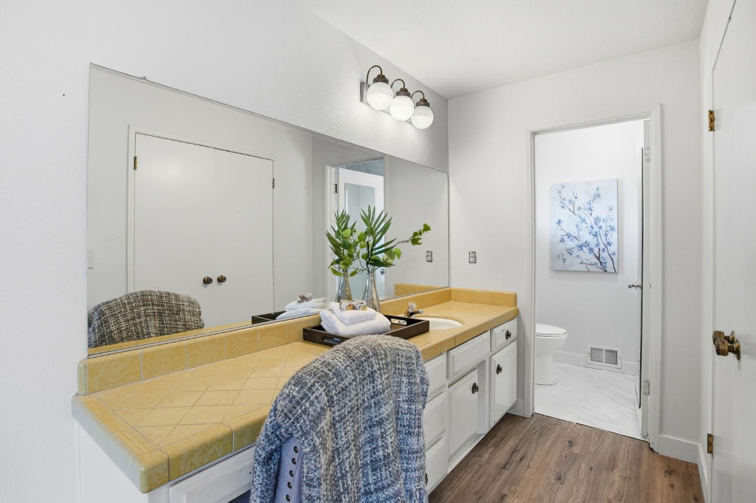 6923 Pera Drive Rancho Murieta, CA 95683 - Photo 21 of 35 a spacious bedroom with a bed and a chandelier