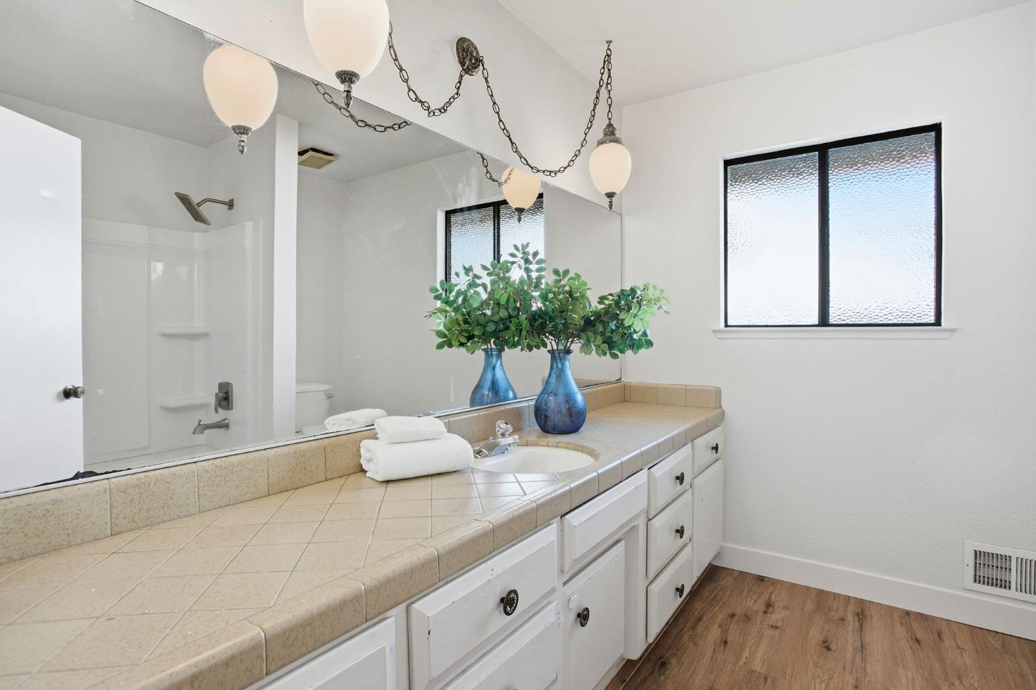 6923 Pera Drive Rancho Murieta, CA 95683 - Photo 22 of 35 a bathroom with a granite countertop sink a mirror and a potted plant