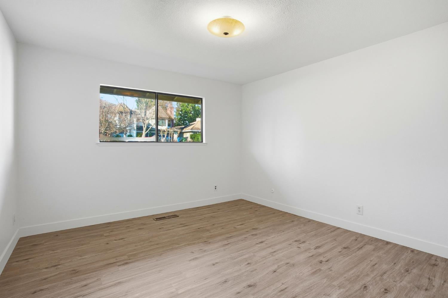 6923 Pera Drive Rancho Murieta, CA 95683 - Photo 24 of 35 wooden floor in an empty room with a window