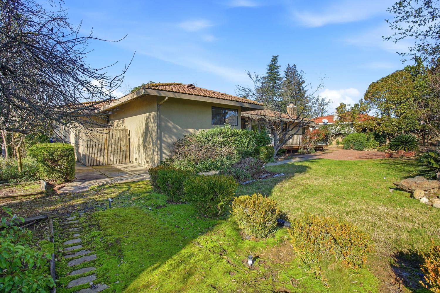 6923 Pera Drive Rancho Murieta, CA 95683 - Photo 35 of 35 a yellow and red house with a yard