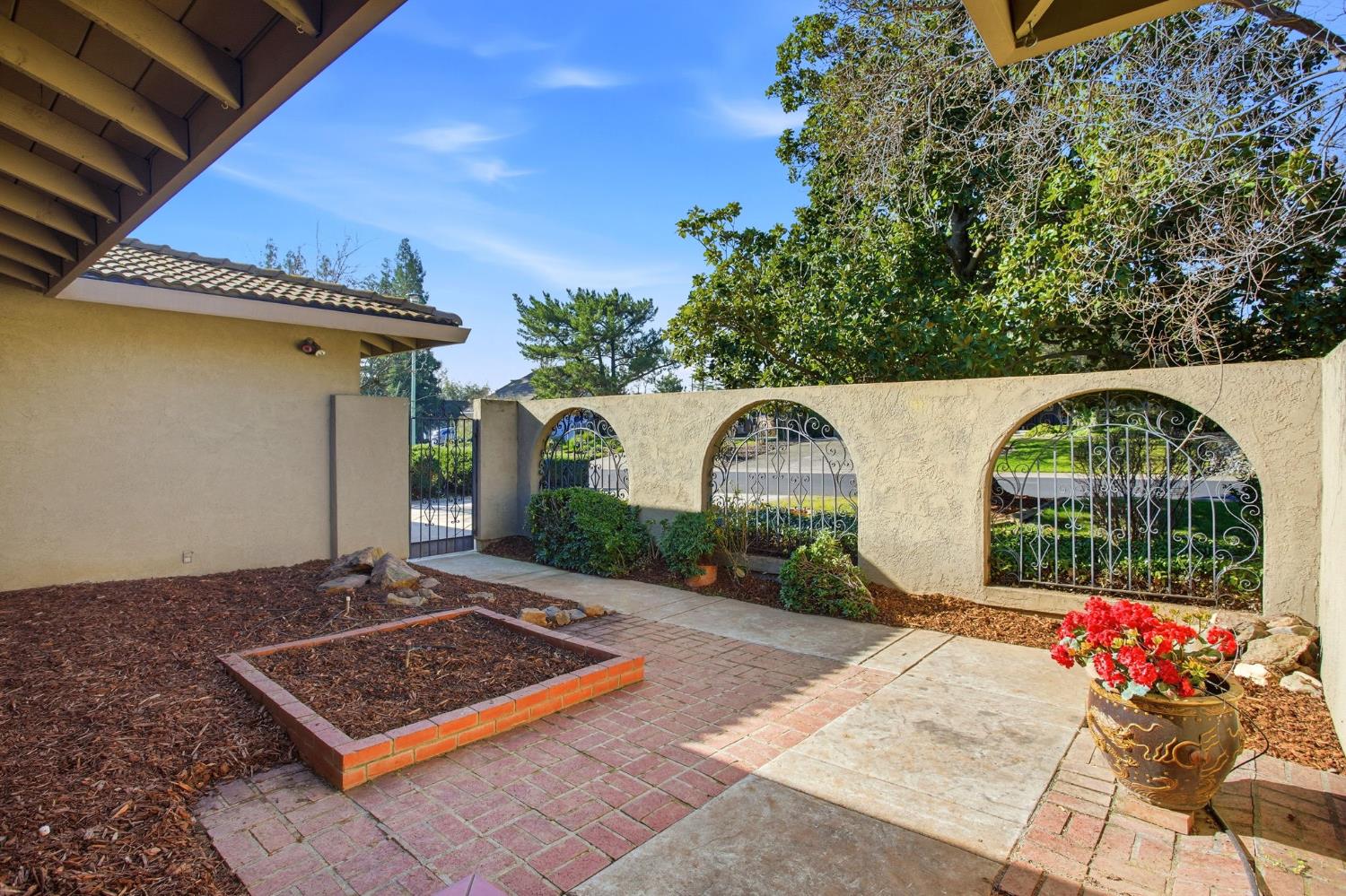 6923 Pera Drive Rancho Murieta, CA 95683 - Photo 4 of 35 a front view of a house with garden