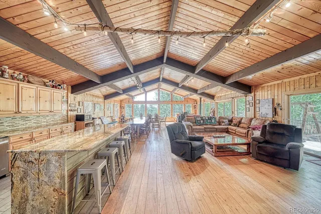 a living room with lots of wooden furniture and a table