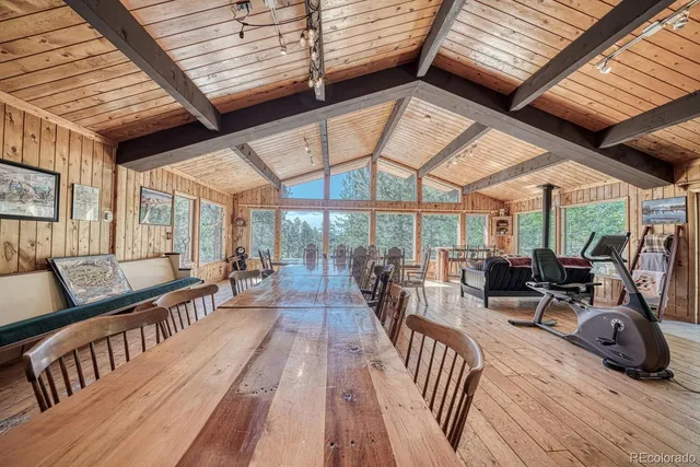 a view of a patio with table and chairs and wooden floor