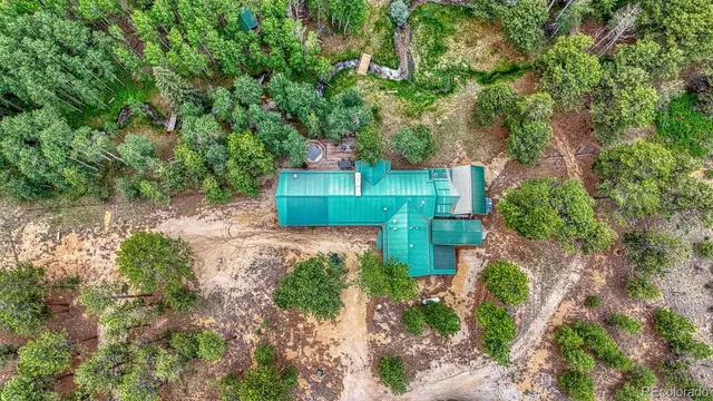 an aerial view of a house with a yard