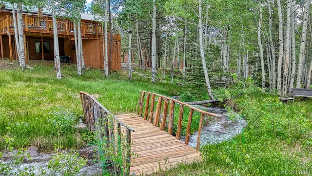 a view of a house with backyard and porch