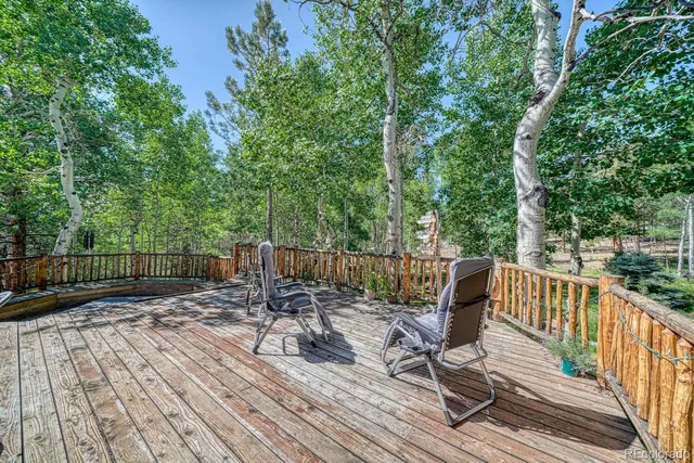 a view of balcony with wooden floor and outdoor seating
