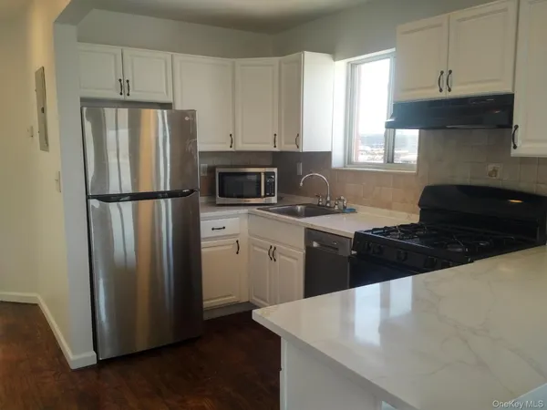 a kitchen with a refrigerator stove and sink