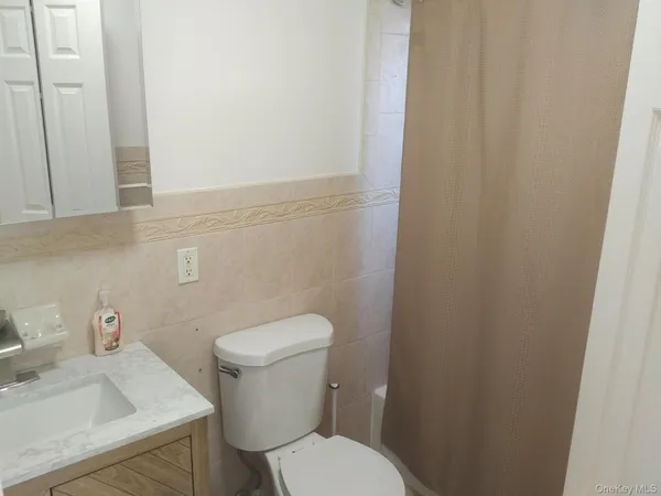 a white toilet sitting next to a bathroom sink