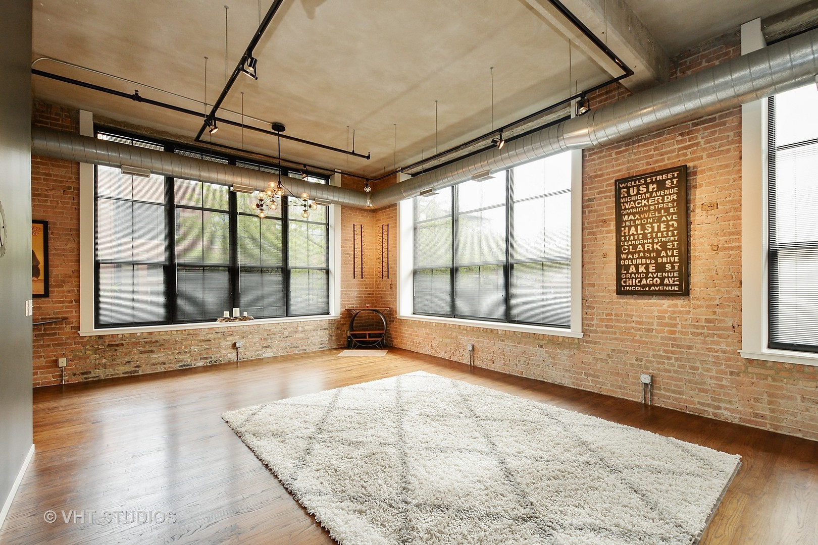 817 West Washington Boulevard, Unit 103 Chicago, IL 60607 - Photo 2 of 10 a view of an empty room with a window and wooden floor