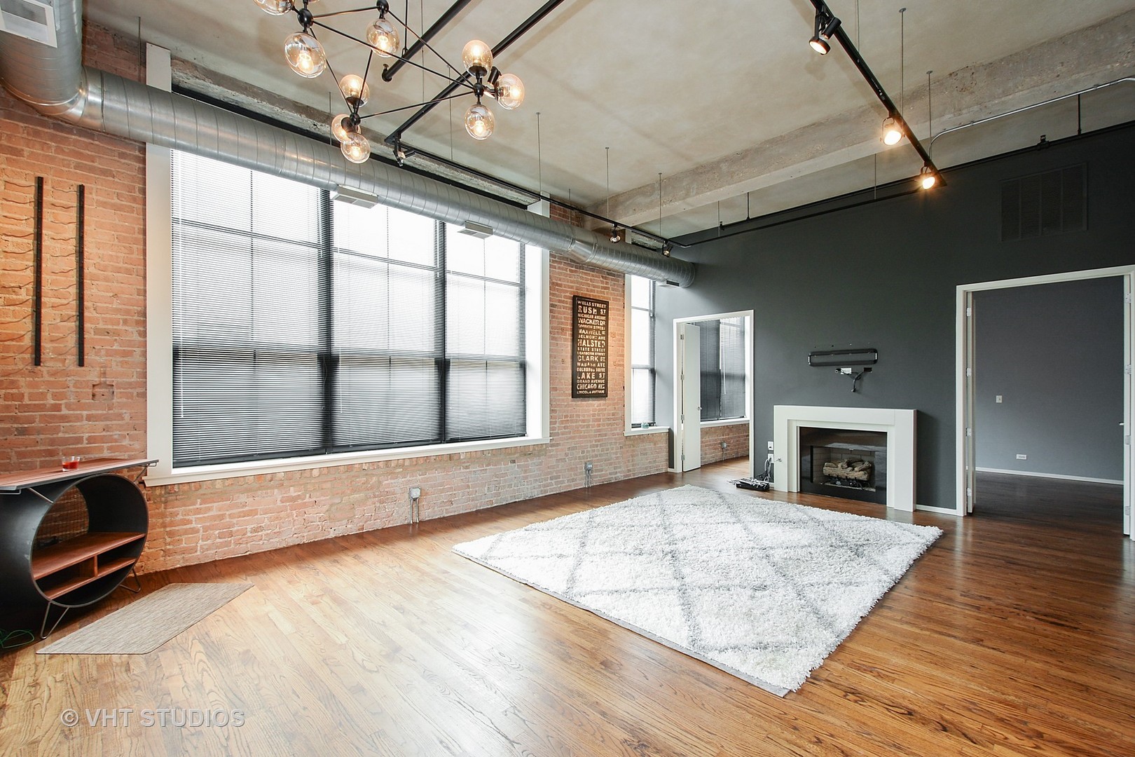 817 West Washington Boulevard, Unit 103 Chicago, IL 60607 - Photo 3 of 10 a view of an empty room with a fireplace and windows