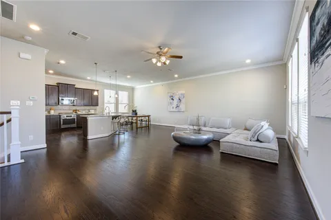 a living room with furniture and kitchen view